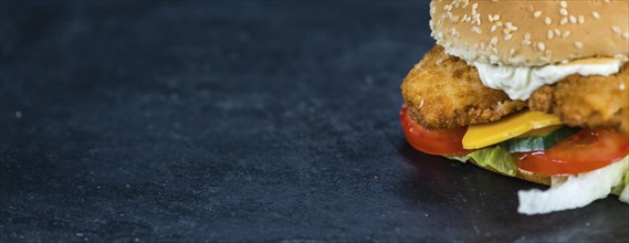 Fish Burger on a slate slab (close-up shot, selective focus)