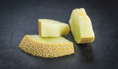 Fresh made Honeydew Melon on a vintage background (close-up shot)