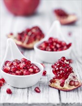 Pomegranate on a vintage background as detailed close-up shot (selective focus)