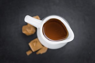 Portion of fresh Caramel Sirup (close-up shot, selective focus)