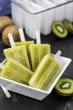 Kiwi Popsicles on a vintage looking slate slab (selective focus)