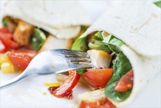 Chicken Wrap (detailed close-up shot, selective focus) on wooden background