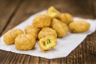 Homemade Cheese Nuggets (with Chilis) on vintage background (selective focus, close-up shot)