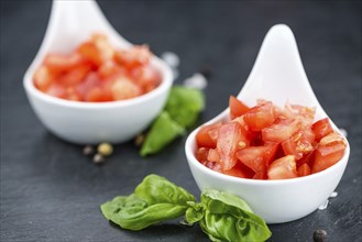 Diced Tomatoes on a vintage background as detailed close-up shot (selective focus)