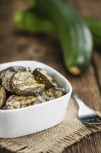 Homemade Antipasti (Grilled Zucchinis) on vintage background (selective focus, close-up shot)