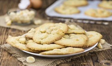 Vintage wooden table with Cookies (selective focus, close-up shot)