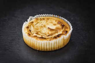 Homemade Cheesecake on vintage background (selective focus, close-up shot)