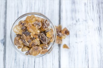 Brown Rock Candy on wooden background (selective focus, close-up shot)