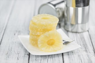 Fresh made Preserved Pineapple Rings on a vintage background as detailed close-up shot