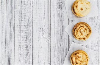 Fresh made Mini Cheesecake on an old and rustic wooden table (selective focus, close-up shot)