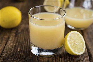 Fresh made Juice (lemon) on a vintage background (close-up shot)