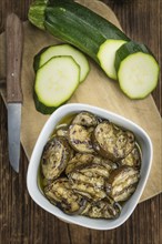 Fresh made Zucchinis (grilled) on an old and rustic wooden table (selective focus, close-up shot)