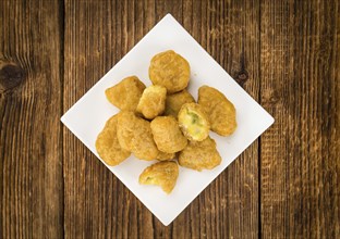 Portion of homemade Chili Cheese Nuggets on wooden background (selective focus, close-up shot)