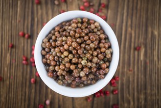 Portion of fresh preserved Pink Peppercorns close-up shot, selective focus