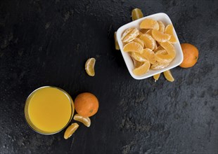 Fresh made Tangerine Juice on a vintage slate slab (selective focus)