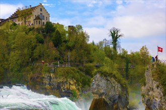 Rhine Falls and Swiss Flag with the Castle Laufen at Neuhausen in Schaffhausen, Switzerland, Europe