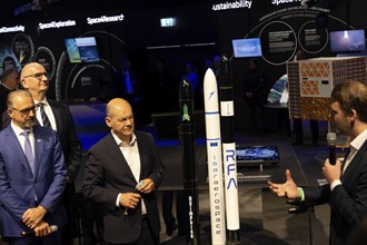 Olaf Scholz (Chancellor of the Federal Republic of Germany, SPD) next to the model of a rocket