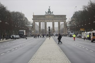 People crossing the road near the Brandenburg Gate on a day of political protest. Berlin, Germany,