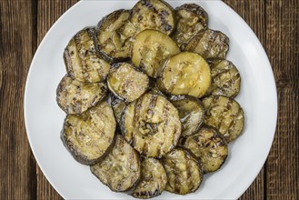 Fresh made Zucchinis (grilled) on an old and rustic wooden table (selective focus, close-up shot)