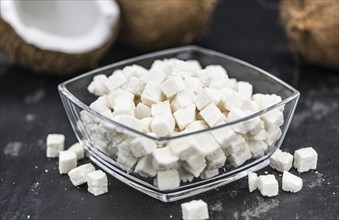 Portion of healthy Coconut dices (selective focus, close-up shot)