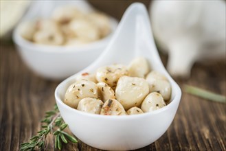 Fresh made Garlic (preserved) on a vintage background (close-up shot)