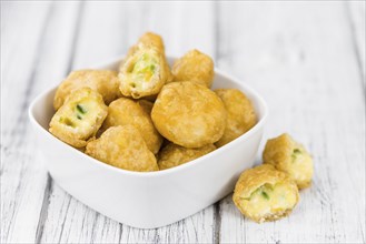 Homemade Cheese Nuggets (with Chilis) on vintage background (selective focus, close-up shot)