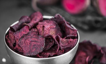 Beetroot Chips on a vintage looking slate slab (selective focus)