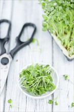 Cress on an old wooden table as detailed close-up shot (selective focus)