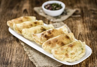 Portion of fresh homemade Empanadas as detailed close-up shot, selective focus