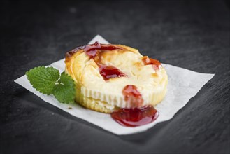 Cheesecake with Sauce on a vintage slate slab (close-up shot, selective focus)