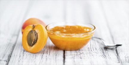 Fresh made Apricot Jam on a vintage background (close-up shot)