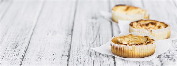 Fresh made Mini Cheesecake on a vintage background (close-up shot)