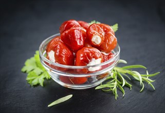 Filled Pimientos on a vintage slate slab (close-up shot, selective focus)