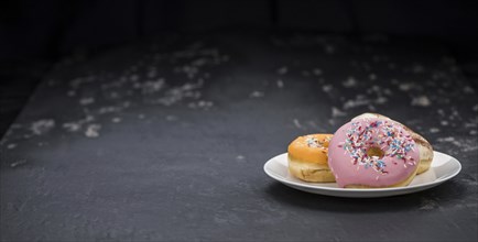 Portion of some Donuts as detailed close-up shot (fresh made, selective focus)