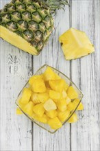 Fresh made Pineapple (sliced) on a vintage background as detailed close-up shot