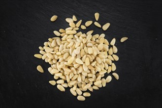 Pine Nuts on a vintage background as detailed close-up shot (selective focus)