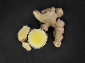 Fresh made Ginger Drink on a slate slab (close-up shot, selective focus)