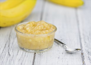 Banana Puree on wooden background (selective focus, close-up shot)