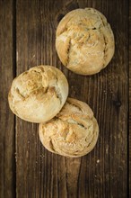 Rolls (German style) on rustic wooden background as close-up shot