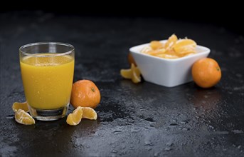 Tangerine Juice (close-up shot) on a vintage looking slate slab