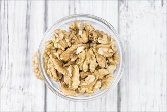 Walnut kernels on a vintage background as detailed close-up shot (selective focus)