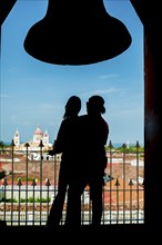 Silhouette of a tourist couple contemplating the Granada cathedral from the La Merced viewpoint