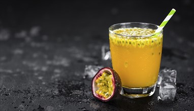 Portion of healthy Maracuja Juice on a slate slab (selective focus)