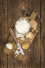 Diced white onions on a vintage background as detailed close-up shot, selective focus