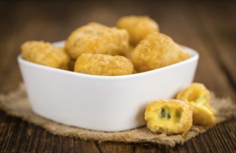 Chili Cheese Nuggets on a vintage background as detailed close-up shot (selective focus)