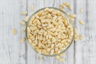 Portion of fresh Pine Nuts (close-up shot, selective focus)