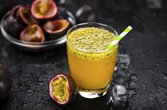 Portion of healthy Maracuja Juice on a slate slab (selective focus)