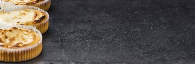 Some fresh Cheesecake on a vintage slate slab (selective focus, close-up shot)