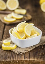 Fresh made Lemon (sliced) on a vintage background (close-up shot)