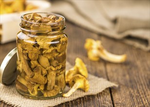 Canned chanterelles on a vintage background as detailed close-up shot, selective focus